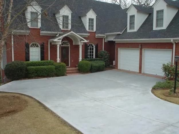 Elegant brick house with manicured lawn and driveway