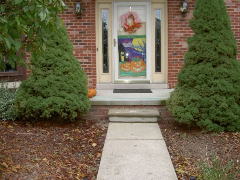 Front porch decorated for Halloween with pumpkins