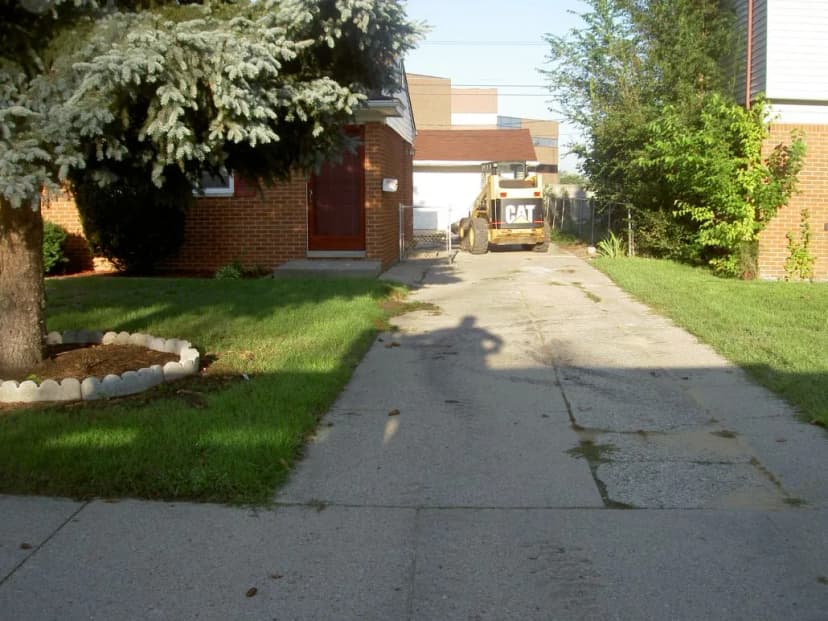 Cat construction vehicle on a home driveway